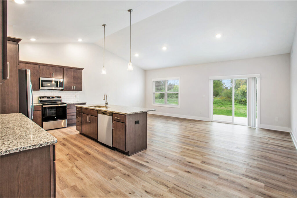 The open area off the spacious kitchen with wood style flooring